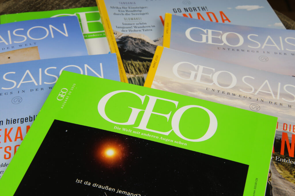 Viersen, Germany - December 20. 2020: Closeup of geo saison paper travel magazines from german gruner and jahr publishing house (focus on issue in front)